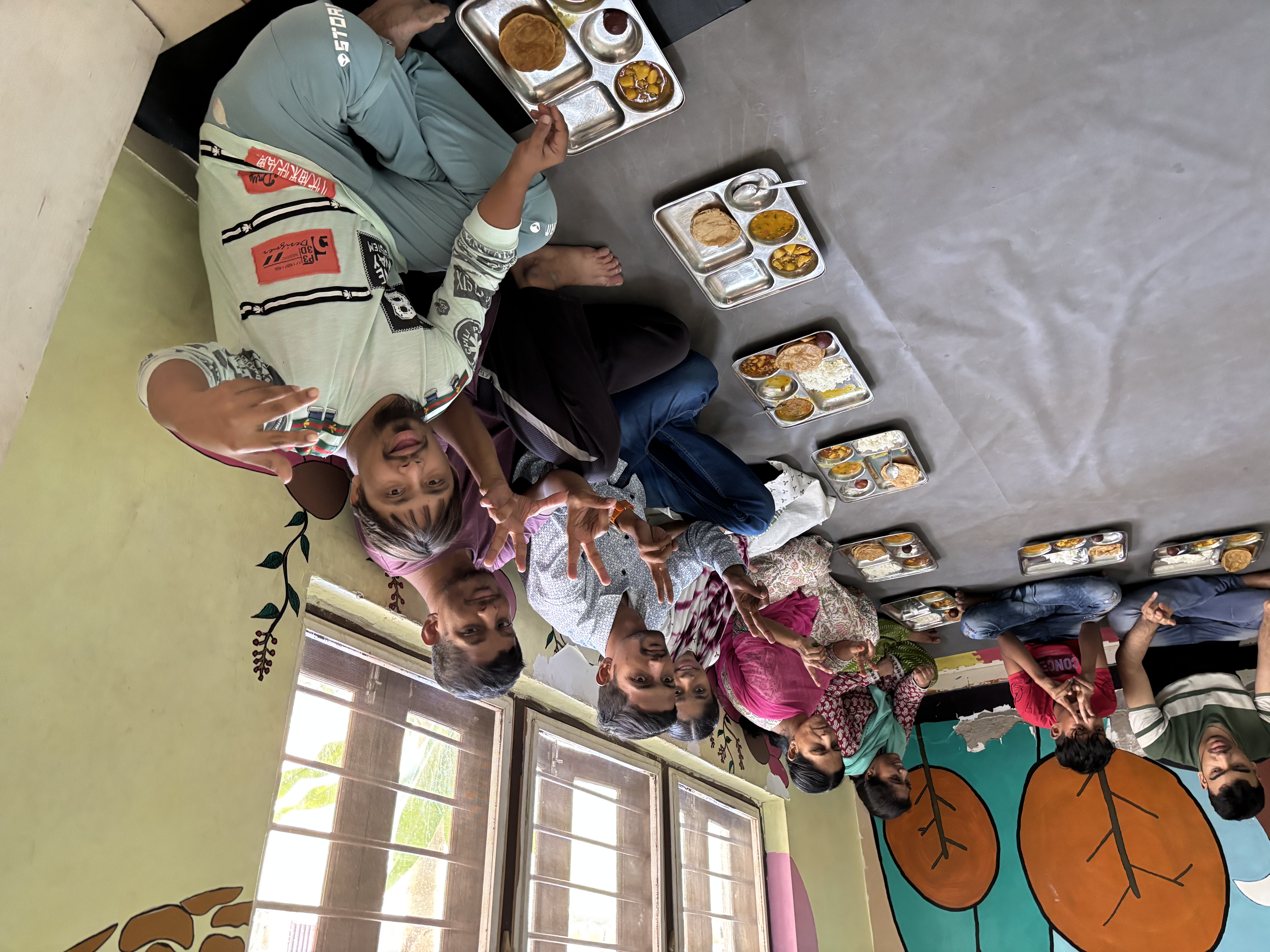 Nutritious meals — beneficiaries sharing warm thali meals together
